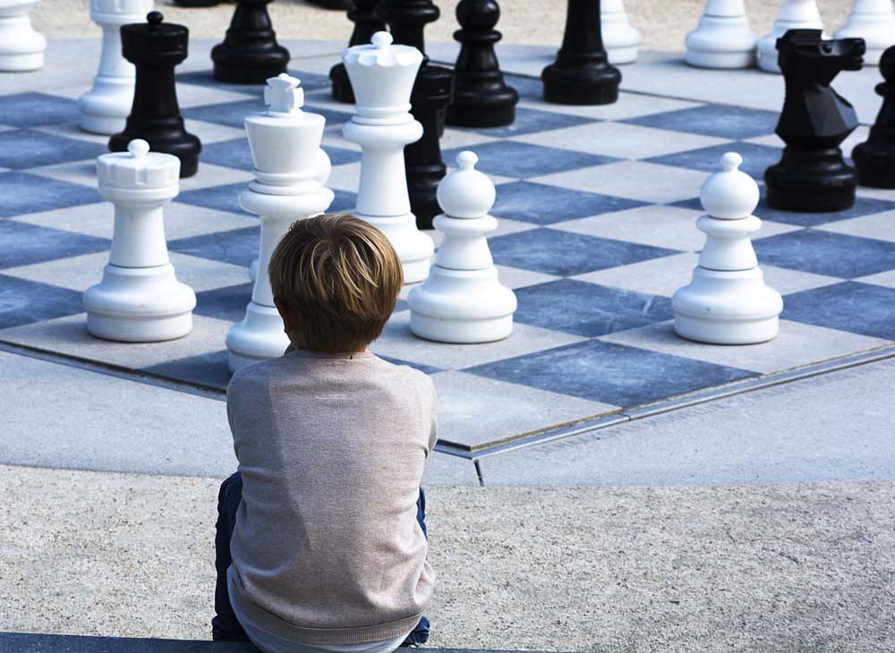 Families and Kids play chess in the library