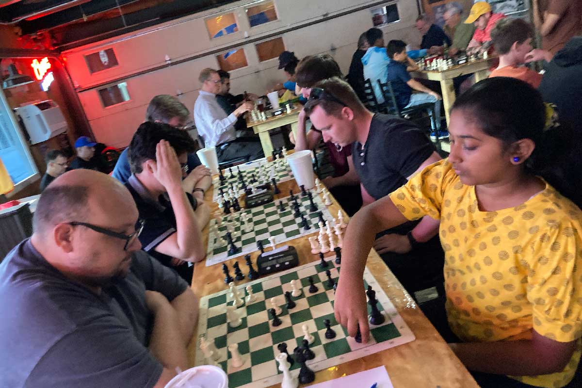 Man and young lady playing blitz chess